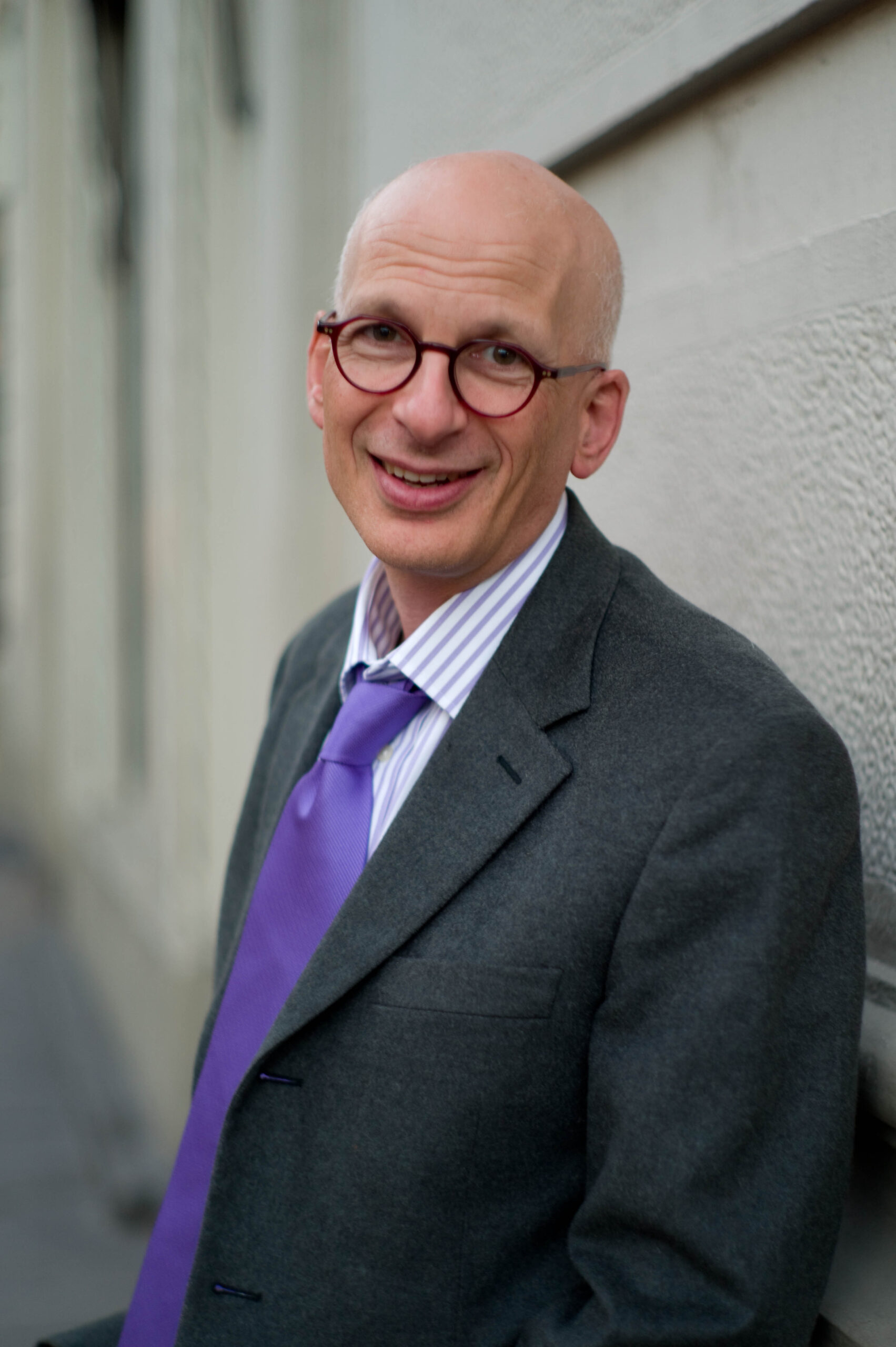 Seth Godin wearing a suit with a purple tie.